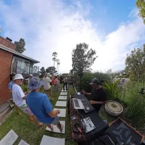 People dancing outside while DJ bhoosh is spinning music